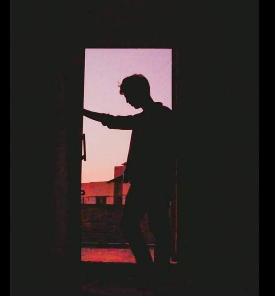 Ek akela ladka andhere kamre ke darwaze par khada hai, shaam ke rang mein dooba hua hai — khamoshi ke us paar ek adhoora sawaal hai: what is love, jab uska jawab sirf tanhaai ho?